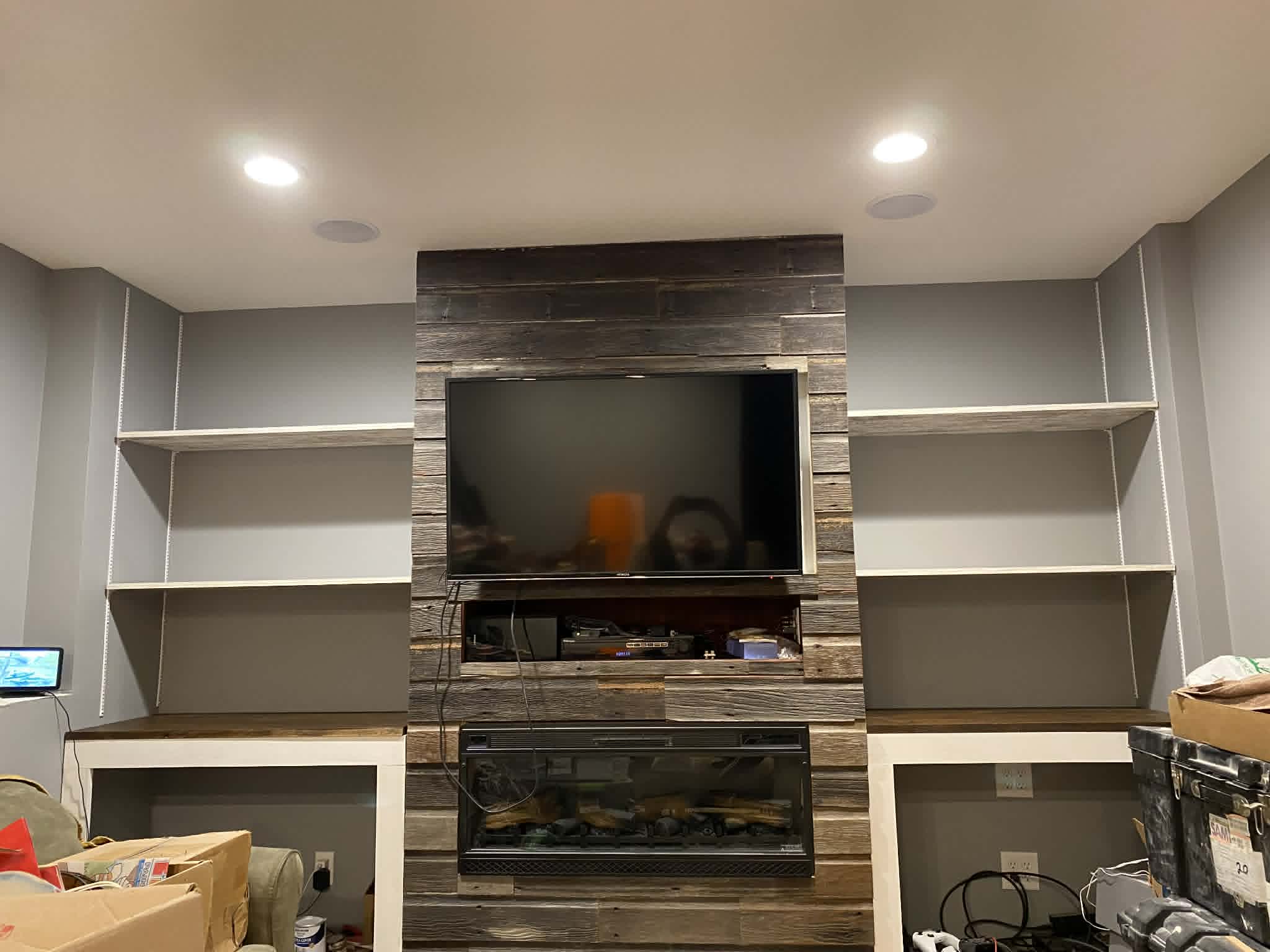 Built-in entertainment wall with fireplace surround and flanking shelving