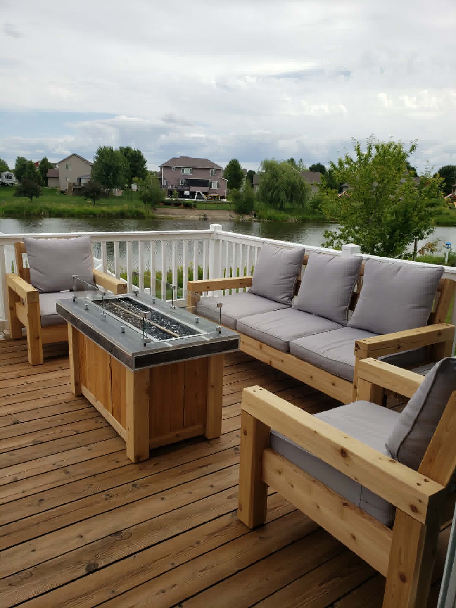 Custom built cedar outdoor sofa, chairs and fire table on a deck
