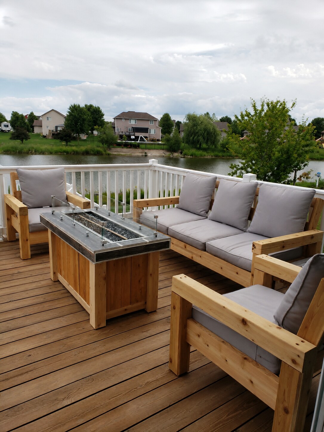 Custom built cedar outdoor sofa, chairs and fire table on a deck